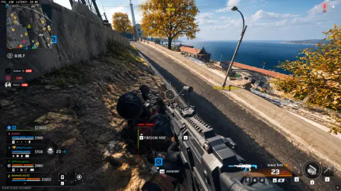 Warzone first-person view on a coastal hillside above a road, aiming at a downed enemy with finishing-move prompts on screen.